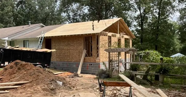 a small house in a fenced in area