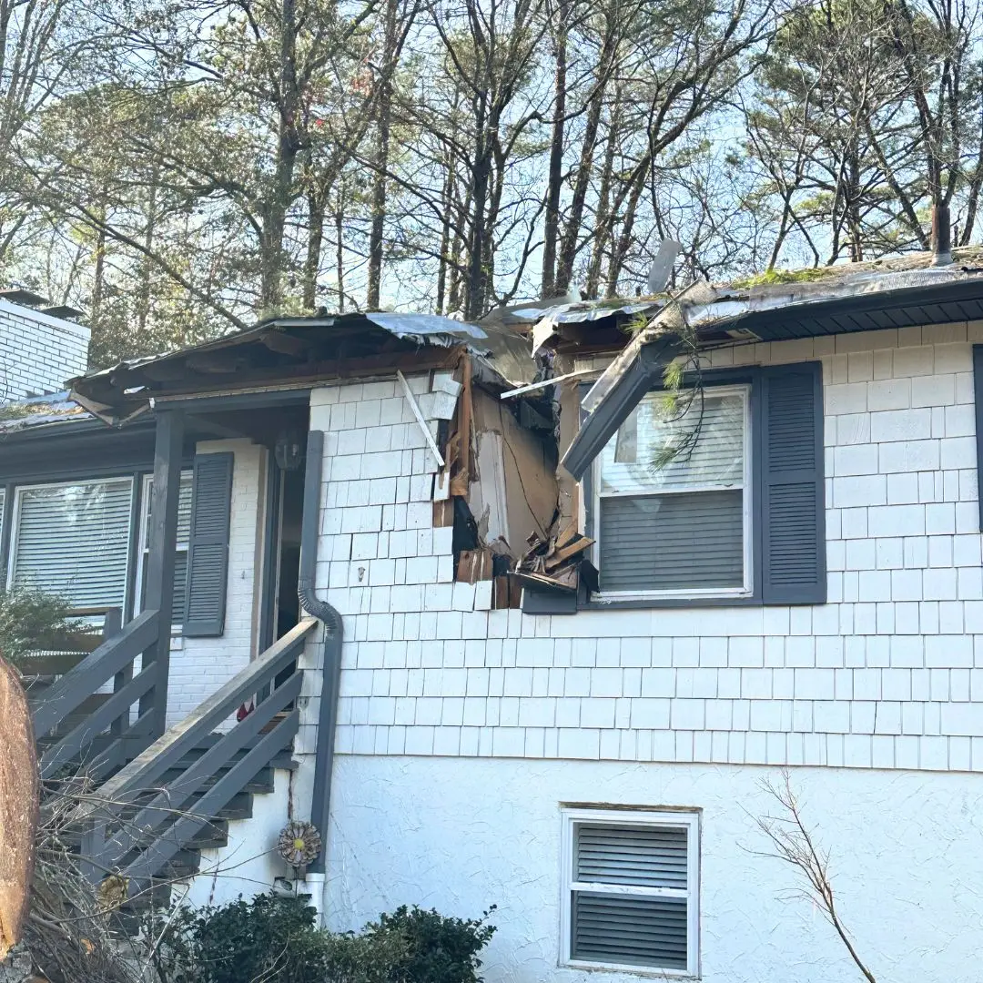 A house in Birmingham, AL, with tree fall storm damage.