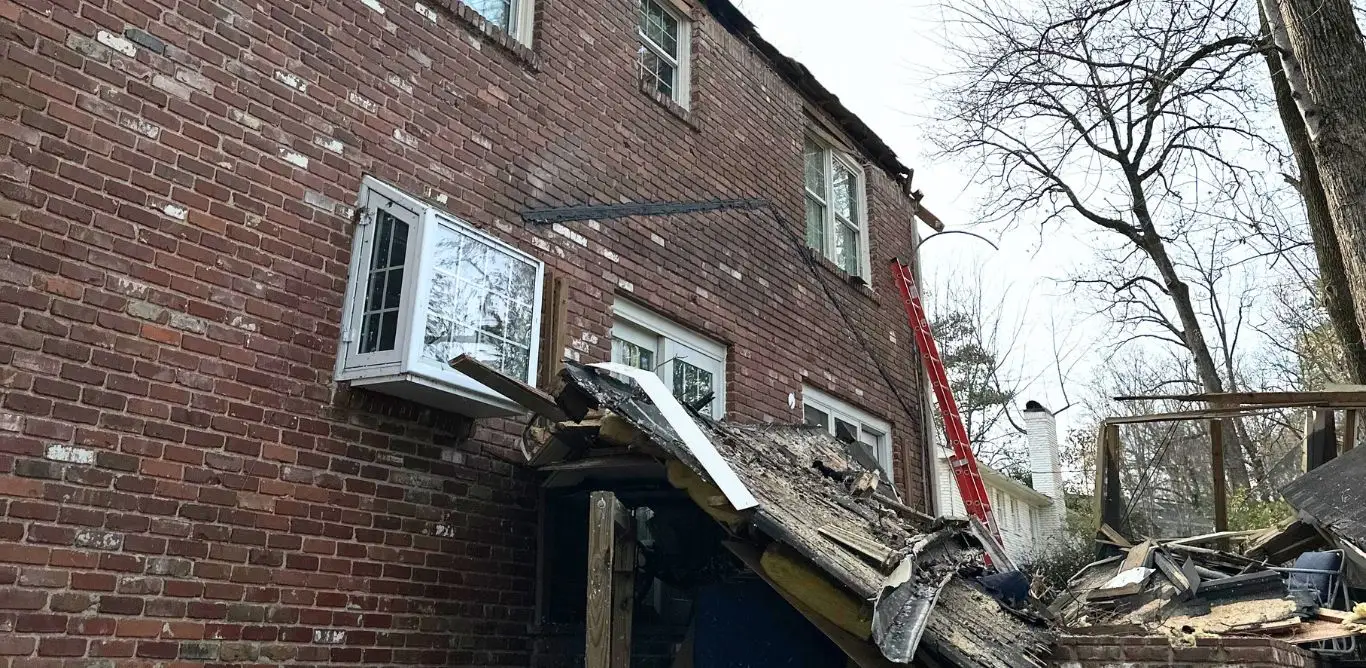 A house in Mountain Brook, AL, with a room addition blown off by storm damage.