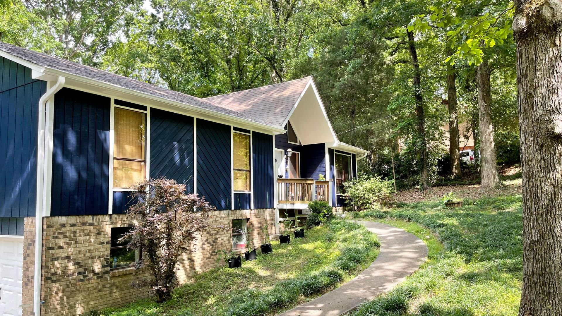 Freshly painted blue siding with white trim.