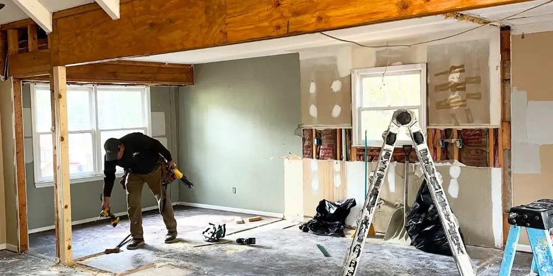 A contractor putting away tools after removing load bearing walls