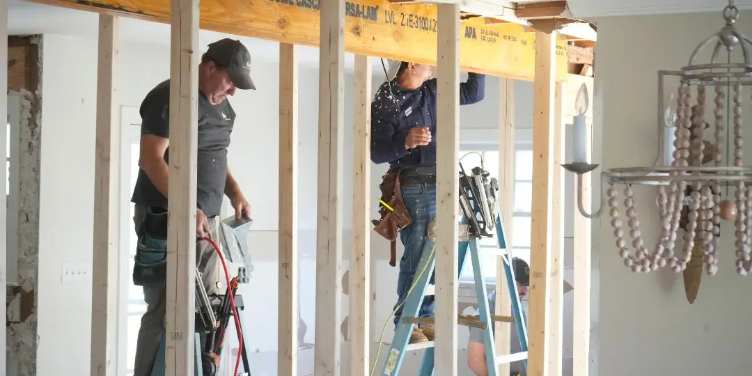 A team bracing a ceiling with studs to remove a load bearing wall