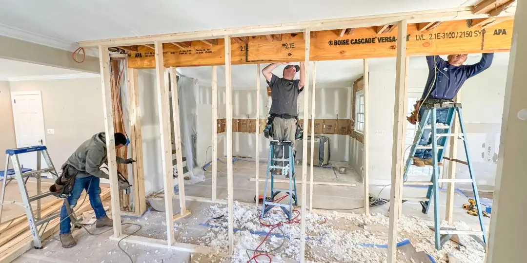 A team on ladders removing a load bearing wall.