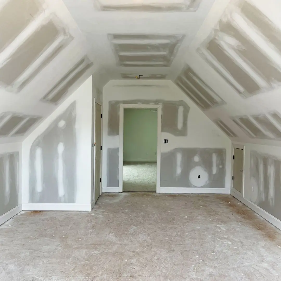 Our attic renovation services, providing a fully drywalled attic room, ready for paint and flooring.