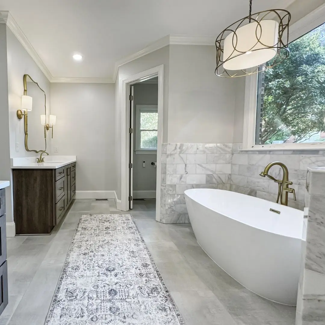 a bedroom with a large tub next to a sink