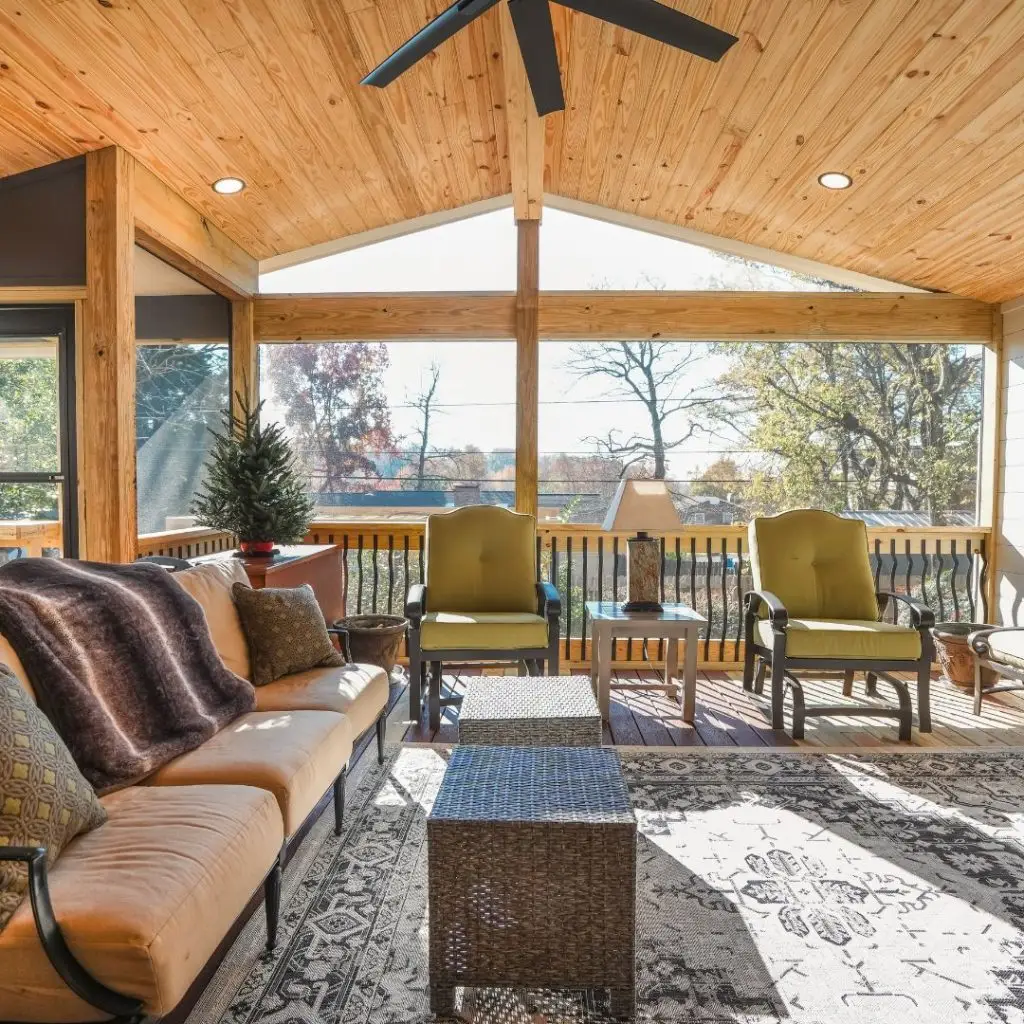 A newly built covered deck, fully furnished, with the sun light shining in.