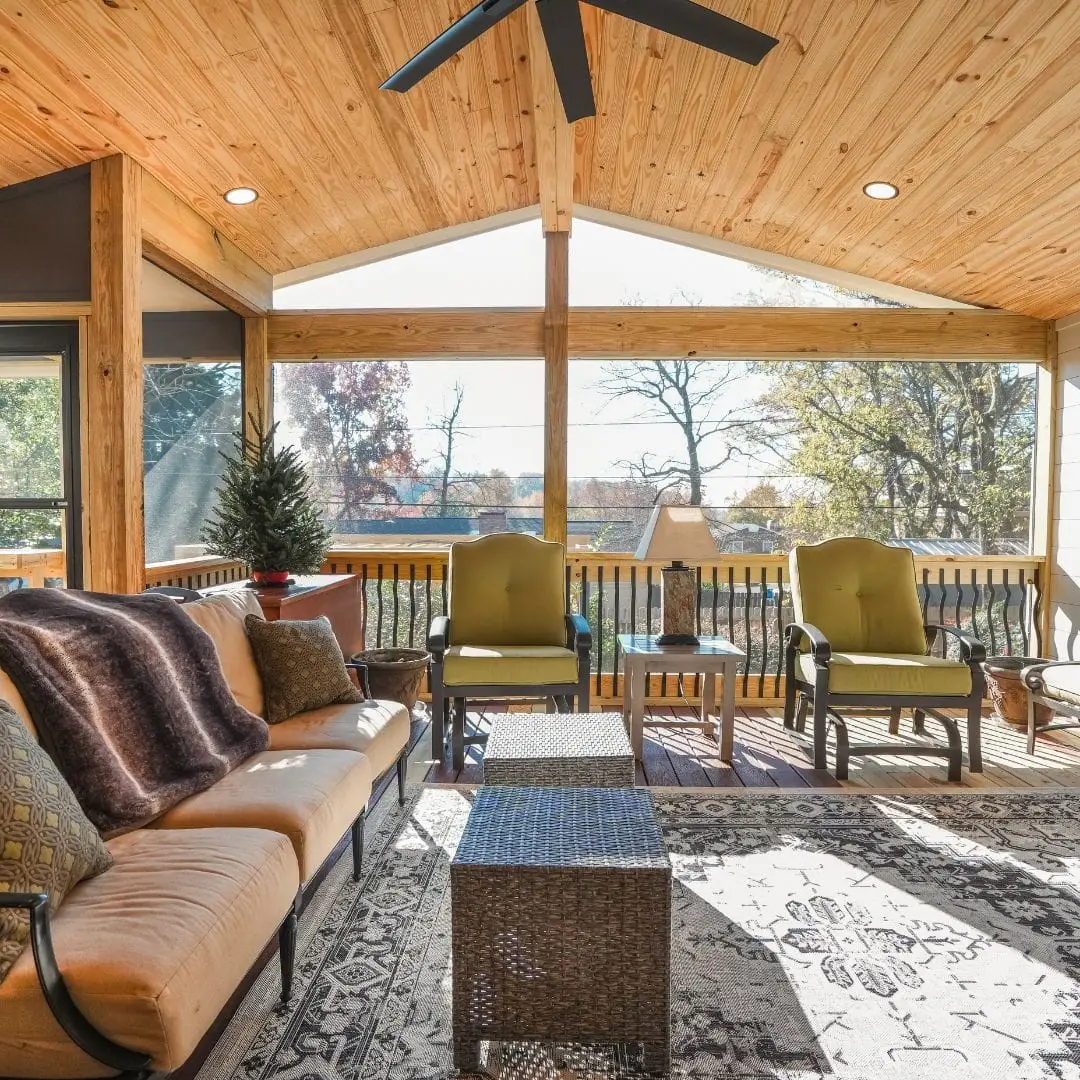 A newly built covered deck, fully furnished, with the sun light shining in.