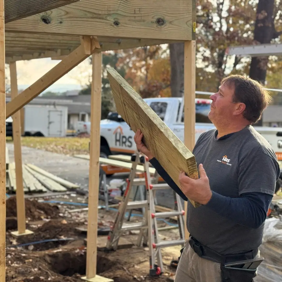 A deck builder repairing a deck.