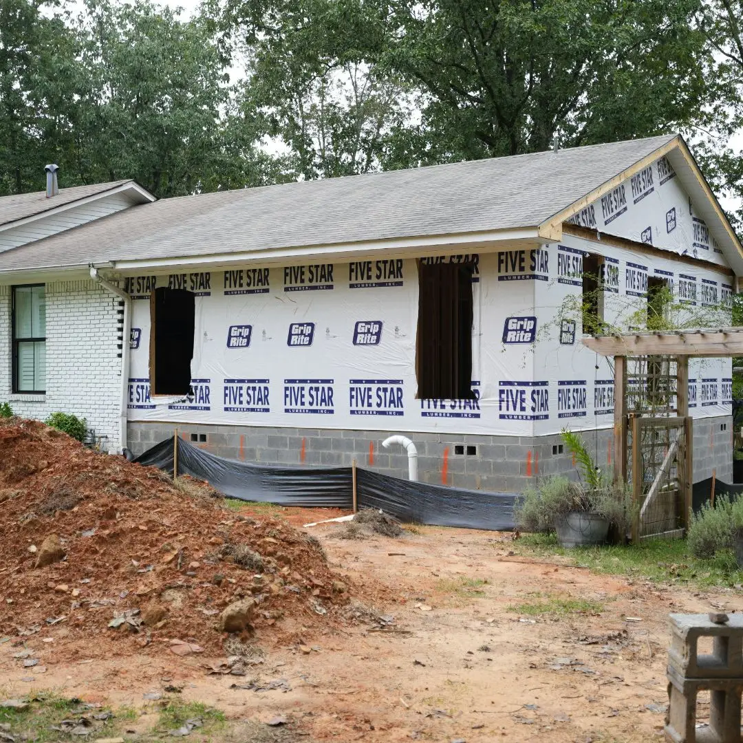 A room addition being built on the right side of a house in Birmingham.