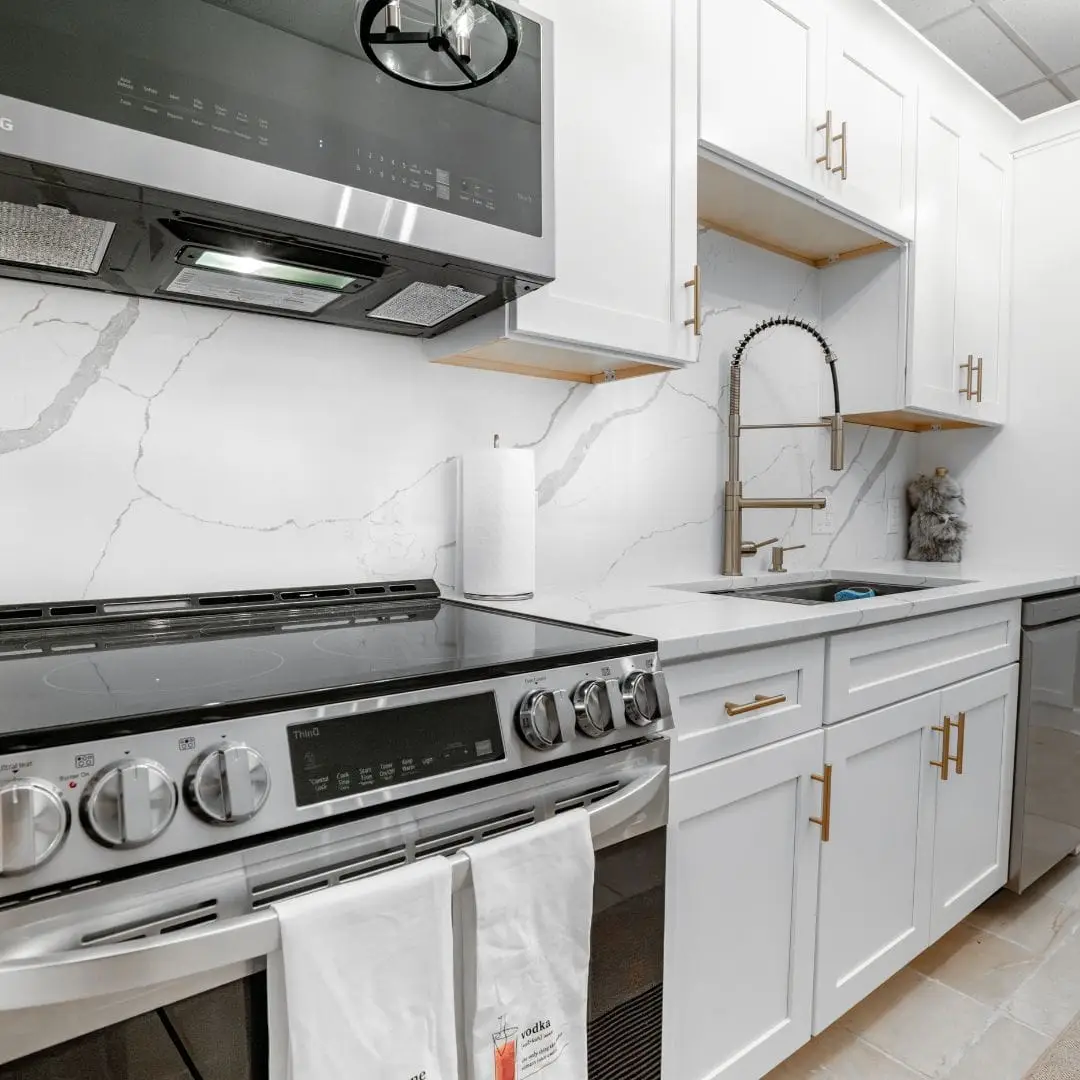 a stove top oven sitting inside of a kitchen