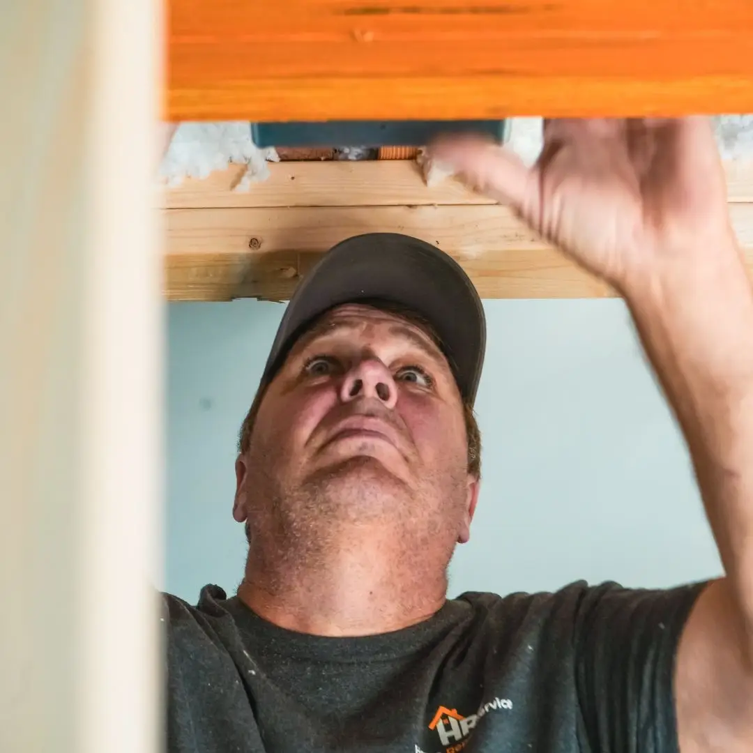 A home remodeler installing an LVL beam to remove a wall.