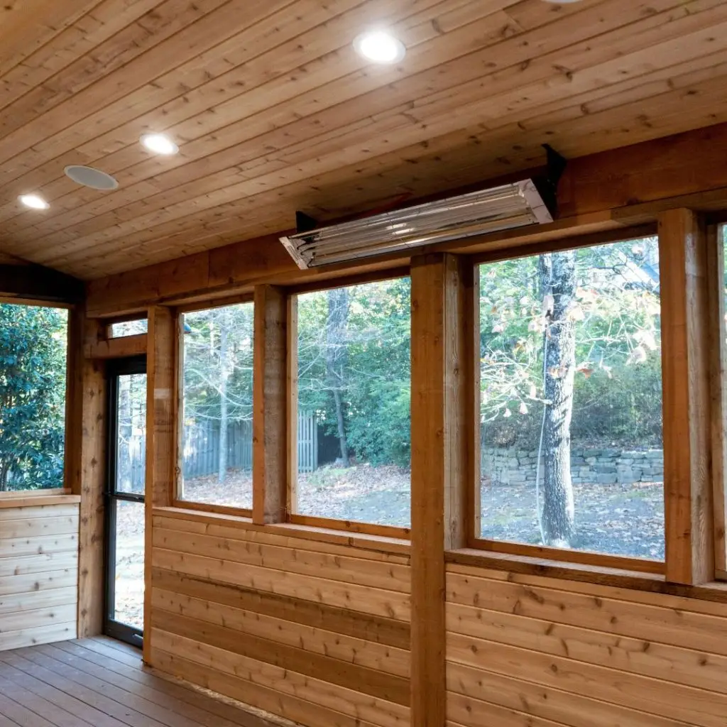 A screened-in porch in Hoover, AL, built using cedar with lighting and a heater on the ceiling.