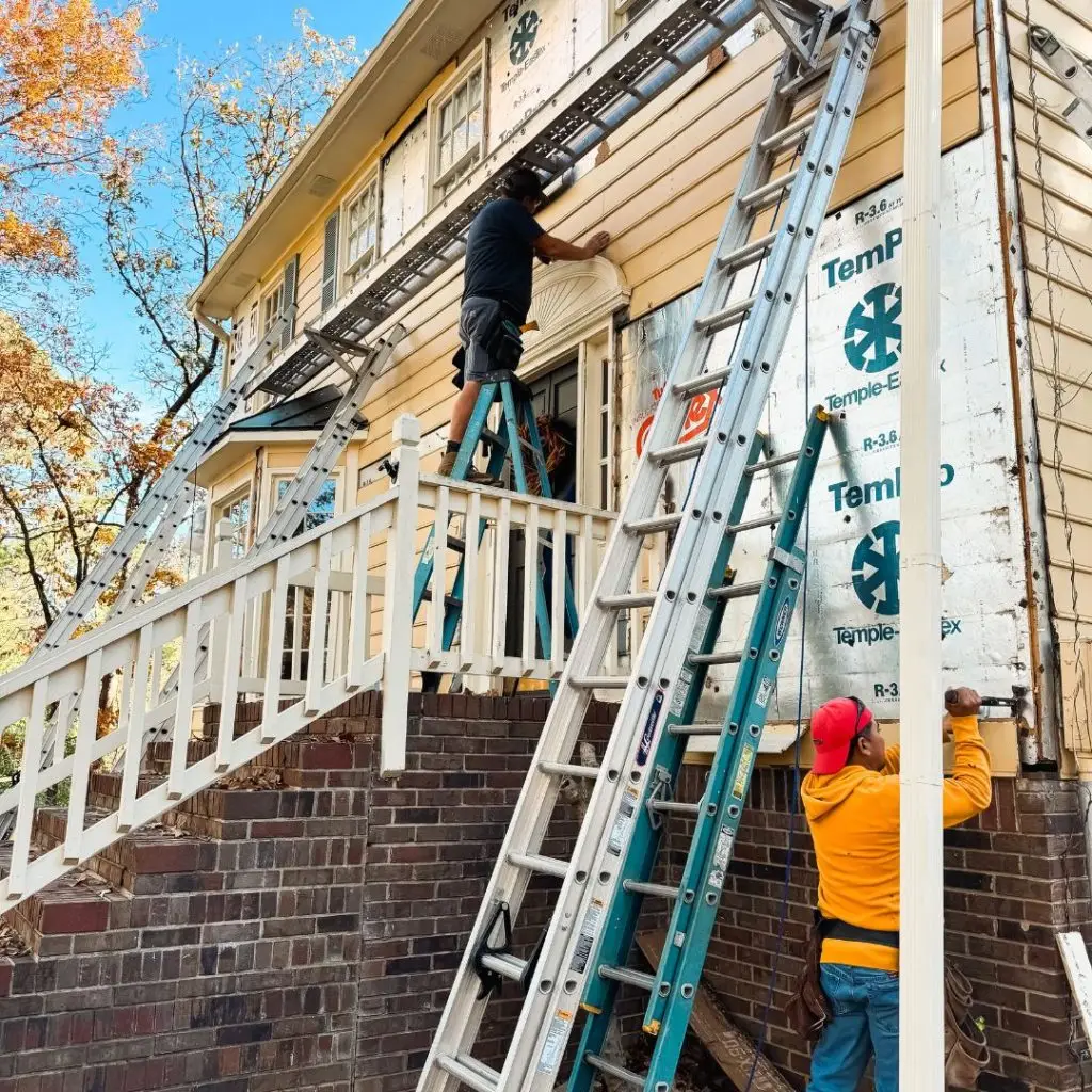 Our team from one of the best siding installation companies in Birmingham, AL, removing masonite siding from a house.