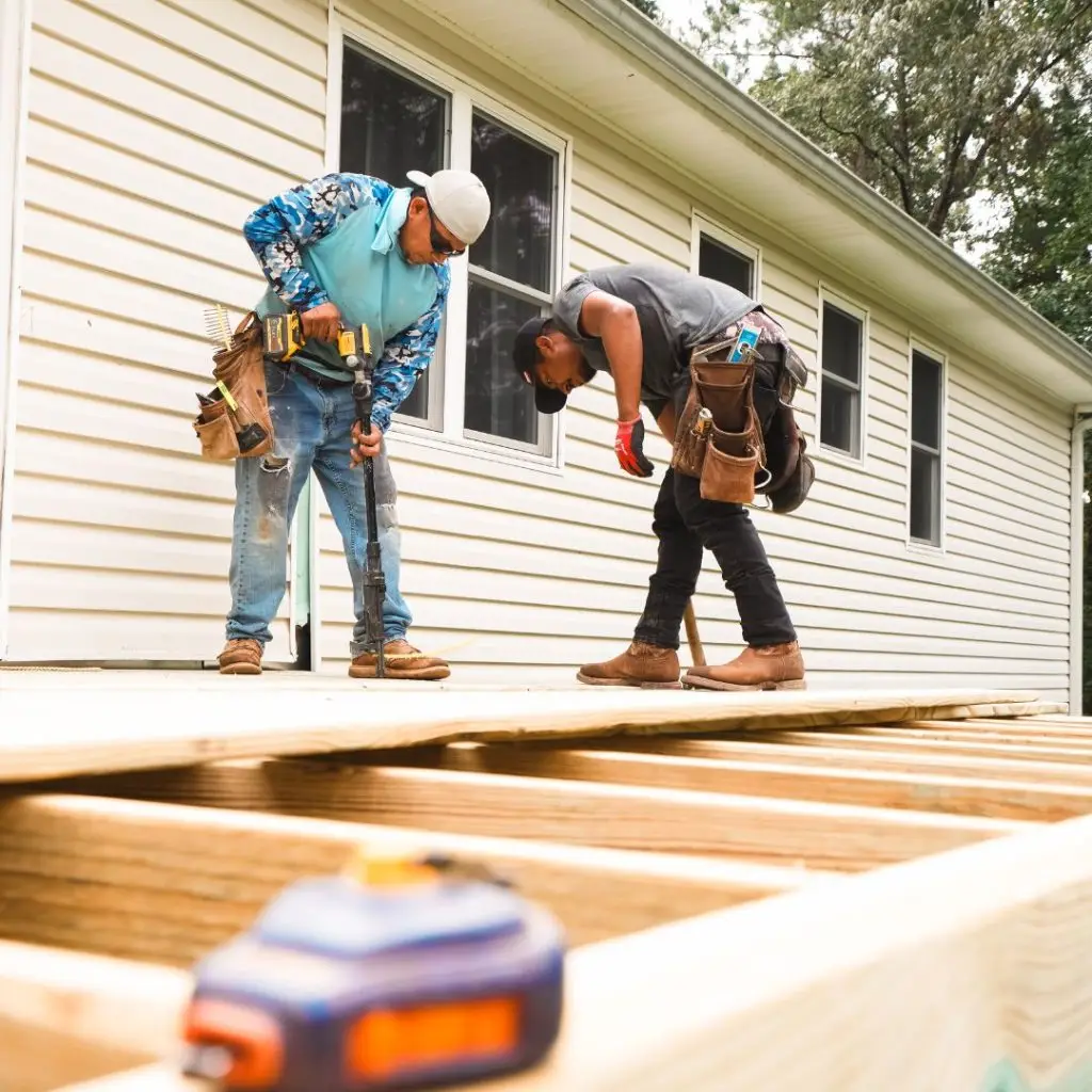 Two of our deck replacement contractors installing deck boards in Hoover, AL.