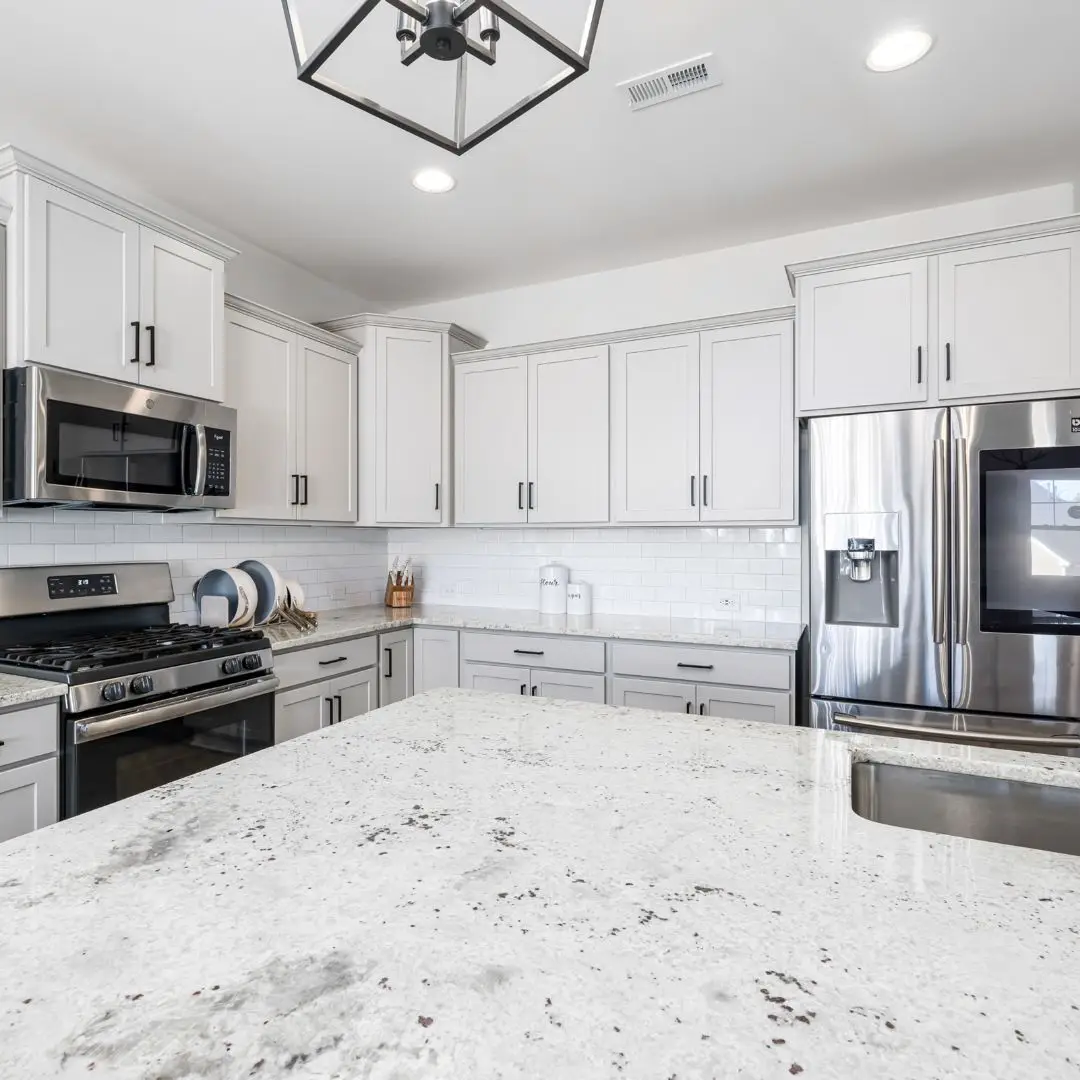 a kitchen with a lot white cabinets