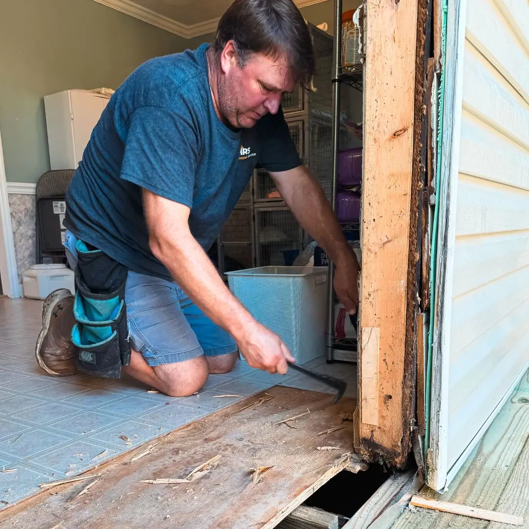 A door repairman fixing a door in Hoover, AL.