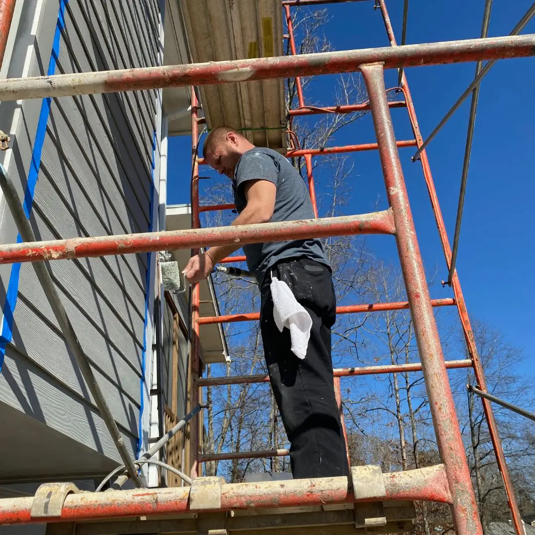 a person standing next to a fence