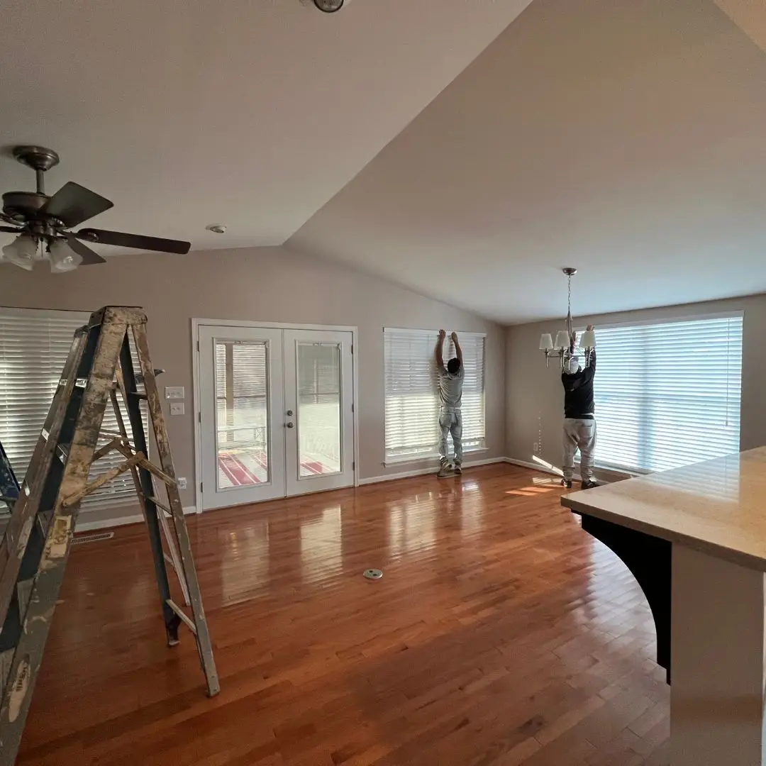 a living room filled with furniture on top of a hard wood floor