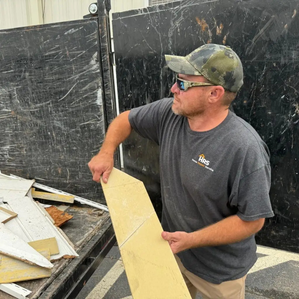 Our siding installation team cleaning up a job site in Vestavia, AL.