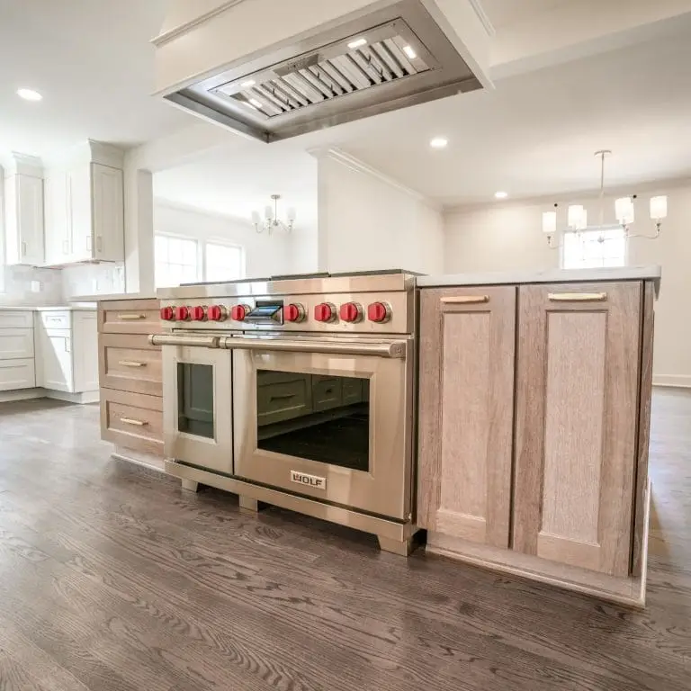 A high-end kitchen island with a Wolf gas range and custom cabinetry, showcasing a spacious layout ideal for those looking to plan a kitchen remodel with a focus on functionality and style.