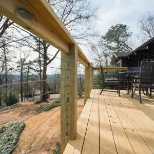 A close-up of the finished 12x18 deck showcases the modern cable railing and durable construction for long-term outdoor use.