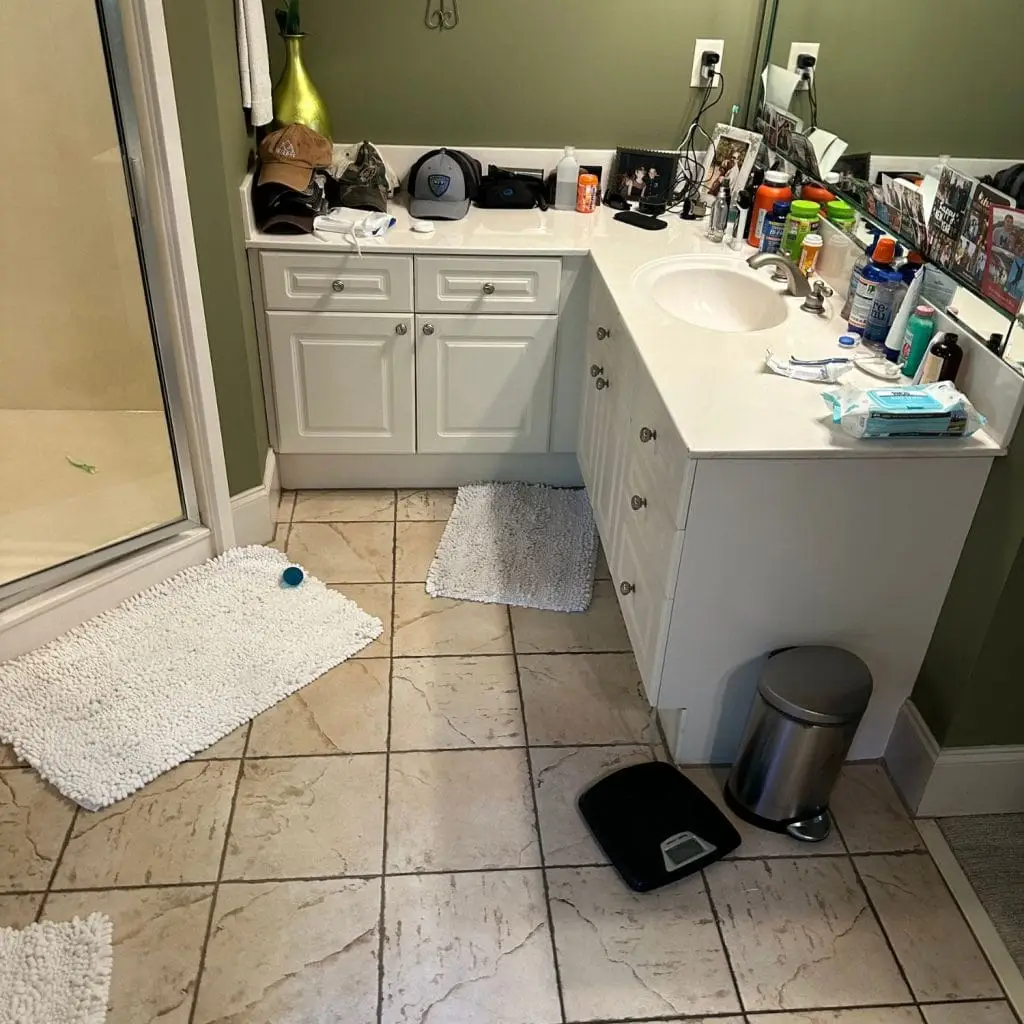 A dated vanity and cluttered layout in need of a remodel, where a new design and upgraded materials can transform the space.