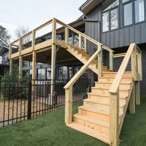A newly built 12x18 deck with a custom staircase and cable railing system enhances the outdoor space of this Birmingham home.