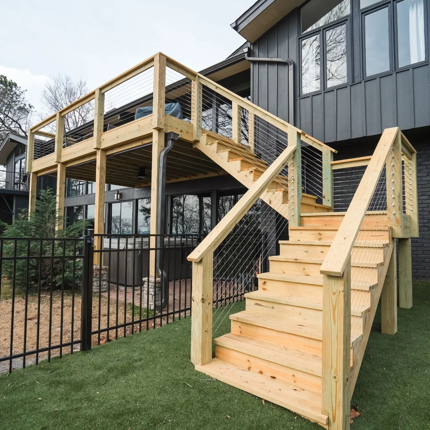 A newly built 12x18 deck with a custom staircase and cable railing system enhances the outdoor space of this Birmingham home.
