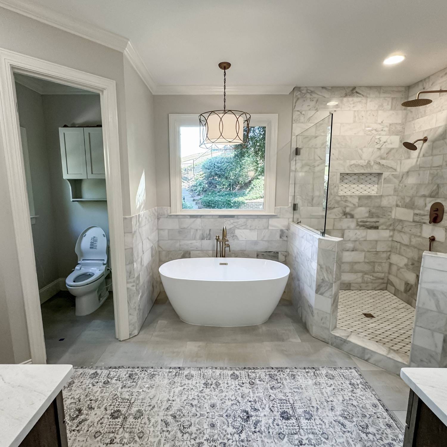 A professional bathroom remodeler transforming a space with elegant tile work, modern fixtures, and a spacious design.