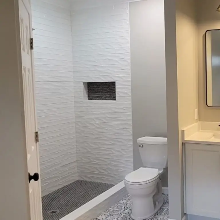 This bathroom showcases a sleek tub to shower conversion with modern tile finishes, providing a real-world example of tub to shower conversion cost in Alabaster, AL.