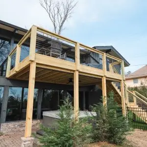This elevated deck with a Trex Rain Escape system and a sleek railing design is a prime example of what to expect when calculating a 12x18 deck cost in Birmingham.