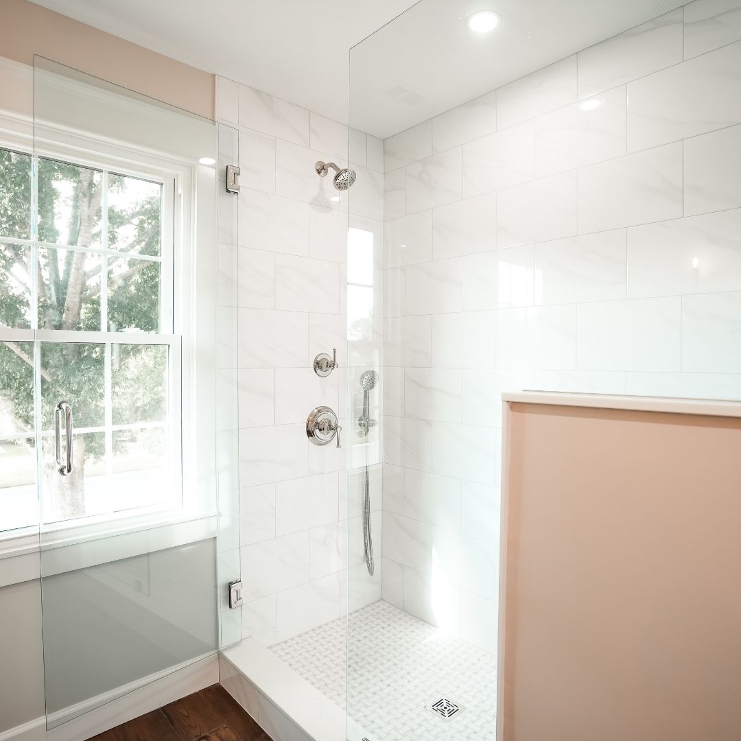 Bathroom remodeling in Vestavia Hills featuring a bright walk-in shower with white tile and chrome fixtures.